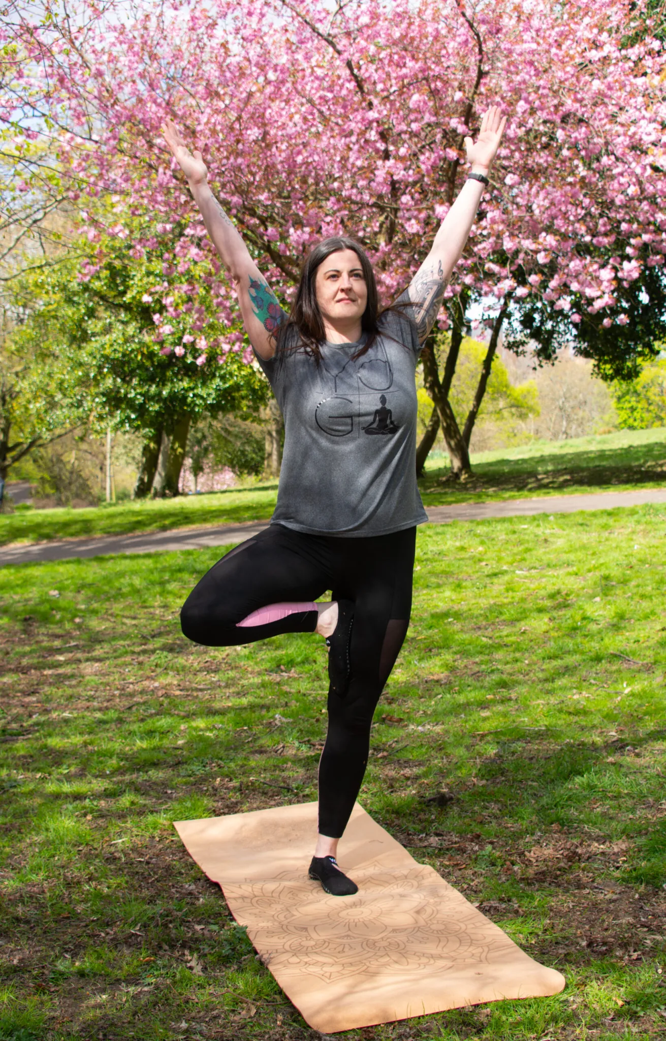 Yoga practice in nature with cherry blossoms